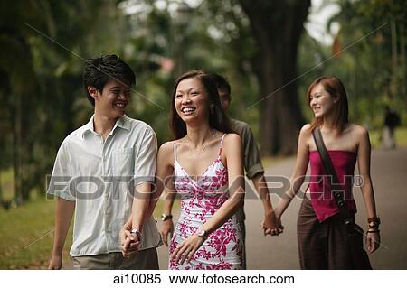 Couples walking hand in hand View Large Photo Image Stock Photography - Couples walking hand in hand. Fotosearch