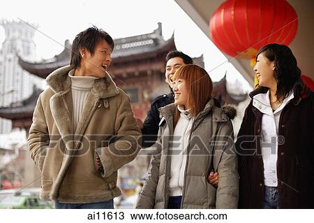 Stock Image - Couples walking side by side, smiling. Fotosearch