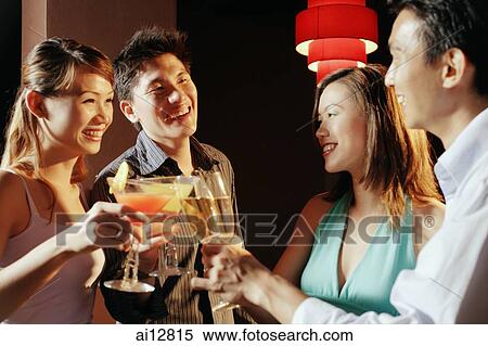 Stock Photography - Couples with drinks, toasting. Fotosearch