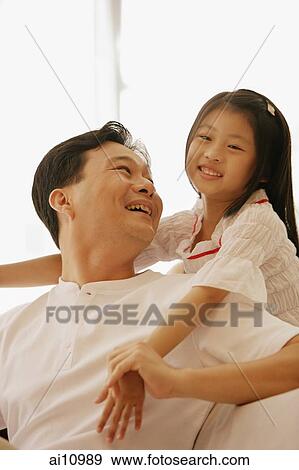 Daughter hugging father from behind View Large Photo Image Stock Photo - Daughter hugging father from behind. Fotosearch