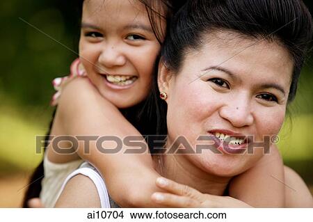 Daughter hugging mother, smiling View Large Photo Image Picture - Daughter hugging mother, smiling. Fotosearch