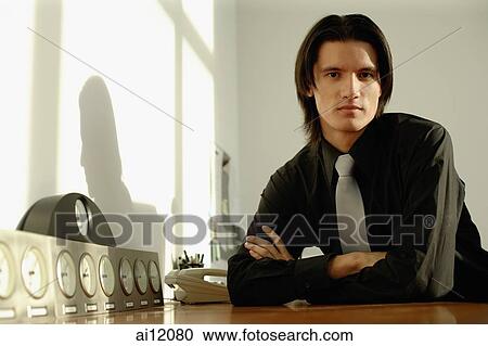 Executive sitting at desk, arms crossed View Large Photo Image Stock Image - Executive sitting at desk, arms crossed. Fotosearch