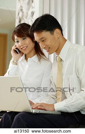 Executives on mobile phone and laptop View Large Photo Image Stock Image - Executives on mobile phone and laptop. Fotosearch