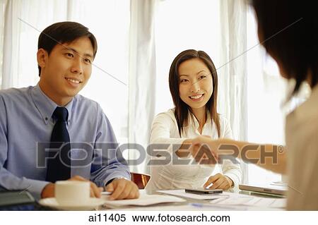 Executives shaking hands across the table. View Large Photo Image Stock Photography - Executives shaking hands across the table.. Fotosearch
