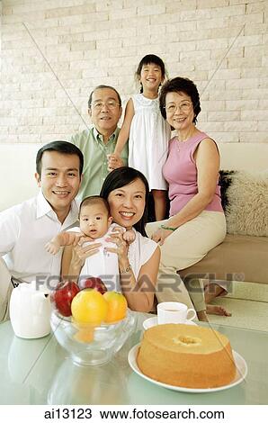 Family portrait, three generations, sitting in living room, looking at camera View Large Photo Image Stock Image - Family portrait, three generations, sitting in living room, looking at camera. Fotosearch