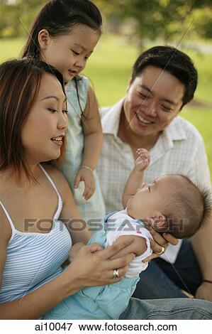 Family sitting together, portrait View Large Photo Image Stock Photo - Family sitting together, portrait. Fotosearch
