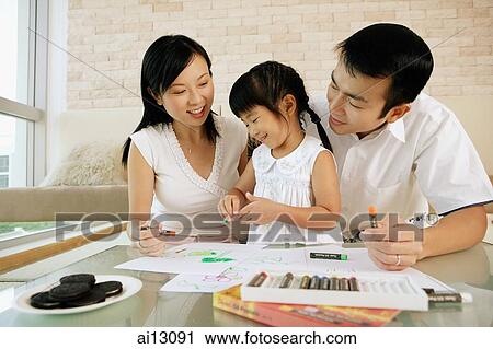 Family with one child, crayons and paper in front of them View Large Photo Image Stock Image - Family with one child, crayons and paper in front of them. Fotosearch