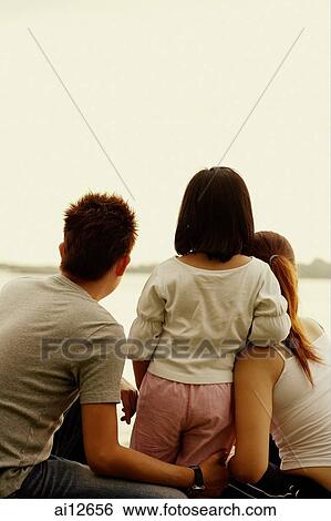Family with one child, rear view View Large Photo Image Stock Photograph - Family with one child, rear view. Fotosearch