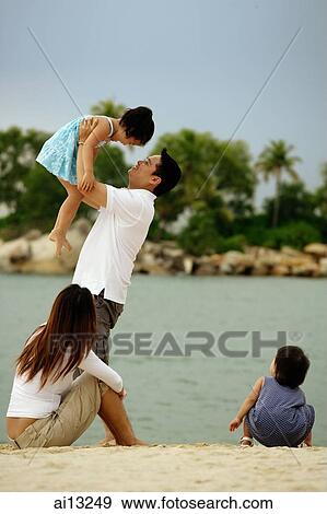 Family with two children on the beach View Large Photo Image Stock Photo - Family with two children on the beach. Fotosearch