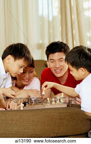 Family with two children playing chess View Large Photo Image Stock Image - Family with two children playing chess. Fotosearch