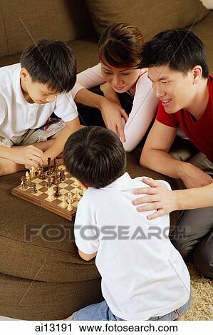 Family with two children playing chess View Large Photo Image Stock Image - Family with two children playing chess. Fotosearch