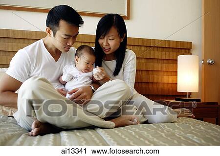 Father and mother holding baby girl View Large Photo Image Stock Image - Father and mother holding baby girl. Fotosearch