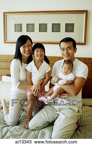 Stock Image - Father and mother with two children, portrait. Fotosearch