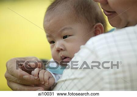 Father carrying baby and touching her hands View Large Photo Image Stock Image - Father carrying baby and touching her hands. Fotosearch