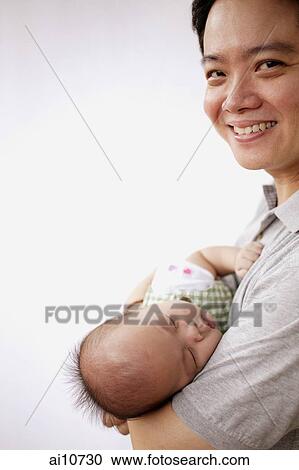 Father carrying baby View Large Photo Image Stock Image - Father carrying baby. Fotosearch