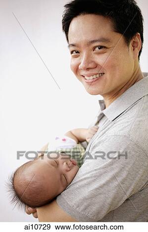 Father carrying infant son View Large Photo Image Stock Photo - Father carrying infant son. Fotosearch