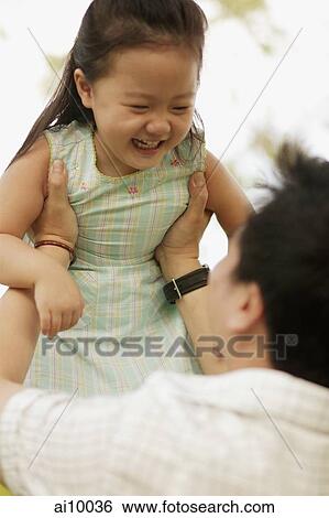 Father carrying young daughter. View Large Photo Image Stock Photograph - Father carrying young daughter.. Fotosearch