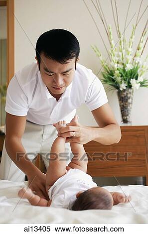 Father changing baby's diapers View Large Photo Image Stock Photography - Father changing baby's diapers. Fotosearch