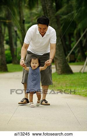 Father walking with daughter, holding hands View Large Photo Image Stock Photography - Father walking with daughter, holding hands. Fotosearch