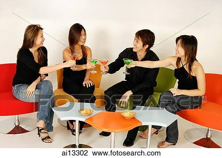 Four adults sitting down, toasting with cocktails View Large Photo Image Stock Image - Four adults sitting down, toasting with cocktails. Fotosearch