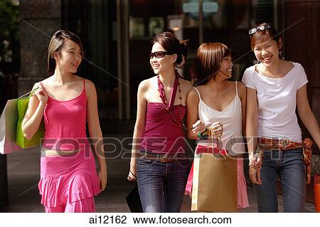 Four young women, side by side, carrying shopping bags View Large Photo Image Stock Image - Four young women, side by side, carrying shopping bags. Fotosearch