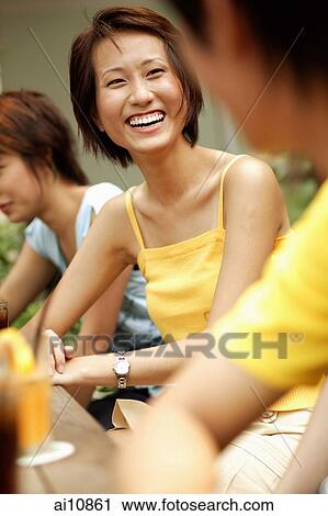 Stock Image - Friends at a cafe. Fotosearch