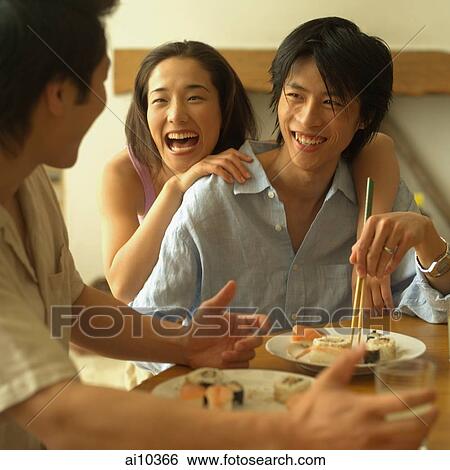 Friends at home, eating sushi View Large Photo Image Stock Photograph - Friends at home, eating sushi. Fotosearch