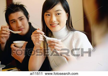 Friends at restaurant, eating soup View Large Photo Image Stock Image - Friends at restaurant, eating soup. Fotosearch