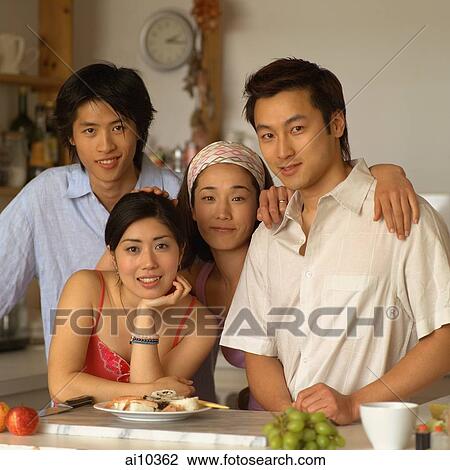 Friends in kitchen, looking at camera View Large Photo Image Stock Image - Friends in kitchen, looking at camera. Fotosearch