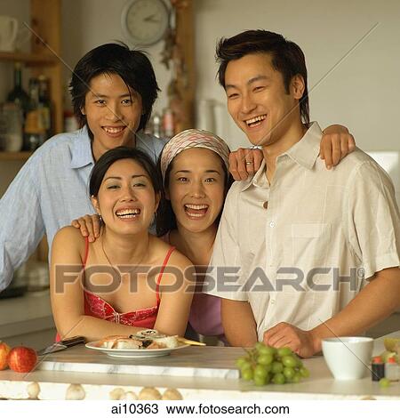 Friends in kitchen, looking at camera, laughing View Large Photo Image Stock Image - Friends in kitchen, looking at camera, laughing. Fotosearch