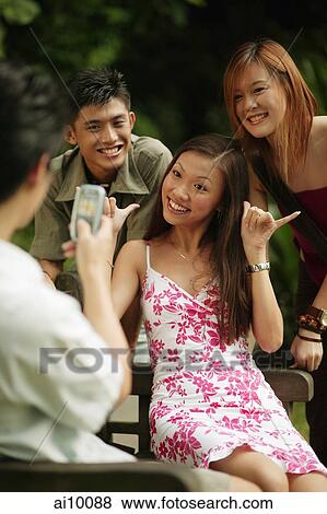 Stock Photo - Friends posing for picture.. Fotosearch