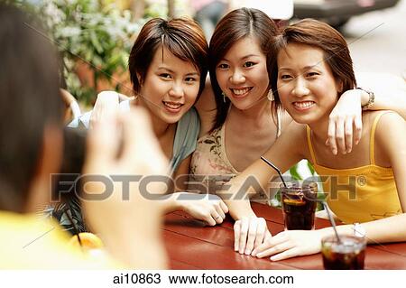 Stock Image - Friends posing for the camera. Fotosearch
