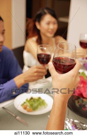 Friends raising wine glass, toasting View Large Photo Image Stock Image - Friends raising wine glass, toasting. Fotosearch