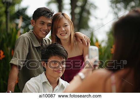 Friends taking a picture with camera phone View Large Photo Image Stock Photo - Friends taking a picture with camera phone. Fotosearch