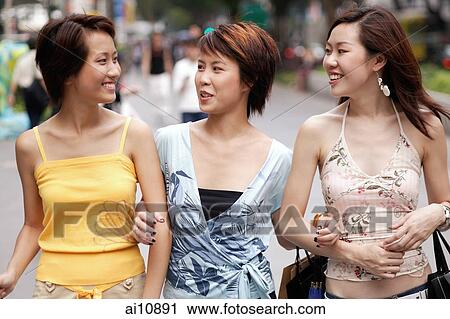 Friends walking side by side, talking View Large Photo Image Stock Image - Friends walking side by side, talking. Fotosearch