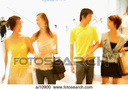 Friends walking side by side, talking View Large Photo Image Stock Image - Friends walking side by side, talking. Fotosearch