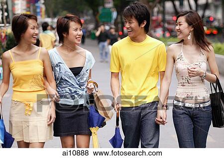 Friends walking side by side, talking View Large Photo Image Stock Photo - Friends walking side by side, talking. Fotosearch