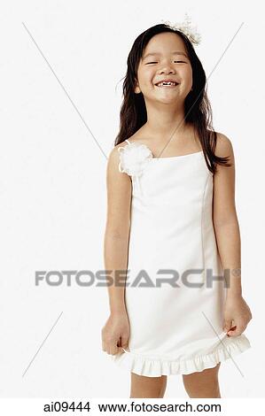 Girl in white dress, smiling View Large Photo Image Picture - Girl in white dress, smiling. Fotosearch