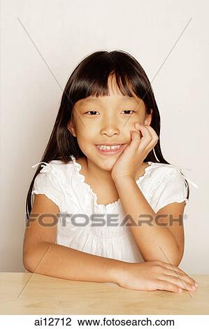 Girl looking at camera, hand on chin View Large Photo Image Stock Image - Girl looking at camera, hand on chin. Fotosearch