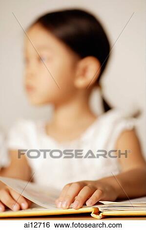 Girl resting hands on book ( selective focus) View Large Photo Image Stock Photograph - Girl resting hands on book ( selective focus). Fotosearch