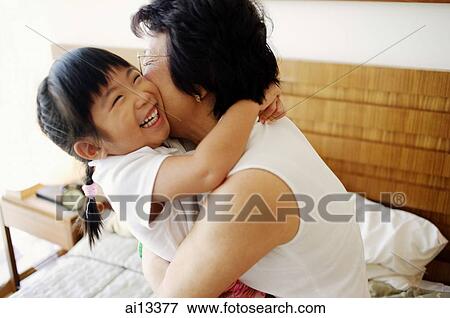 Granddaughter hugging grandmother View Large Photo Image Stock Photo - Granddaughter hugging grandmother. Fotosearch