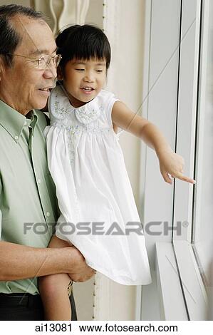 Grandfather carrying granddaughter, looking out the window View Large Photo Image Stock Image - Grandfather carrying granddaughter, looking out the window. Fotosearch