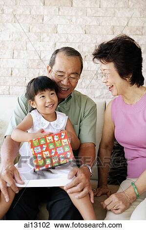 Stock Image - Grandparents with granddaughter. Fotosearch