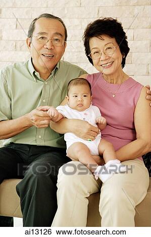 Grandparents with granddaughter, looking at camera, smiling View Large Photo Image Stock Photograph - Grandparents with granddaughter, looking at camera, smiling. Fotosearch