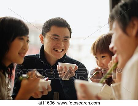 Group of friends eating at a Chinese restaurant, side by side View Large Photo Image Stock Photograph - Group of friends eating at a Chinese restaurant, side by side. Fotosearch