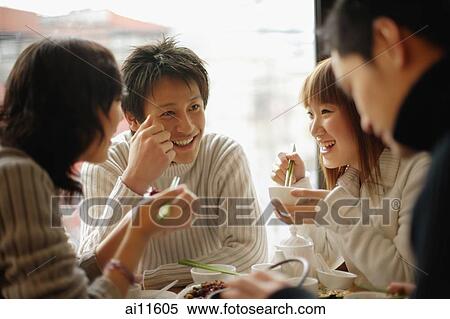 Group of friends eating at a Chinese restaurant View Large Photo Image Stock Photography - Group of friends eating at a Chinese restaurant. Fotosearch