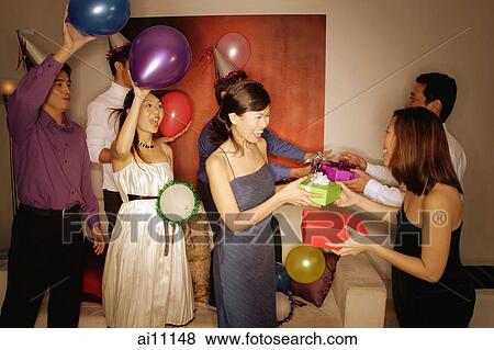 Group of friends exchanging gifts View Large Photo Image Stock Photo - Group of friends exchanging gifts. Fotosearch