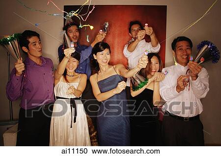Group of friends having a party at home, playing with streamers and noisemakers View Large Photo Image Stock Image - Group of friends having a party at home, playing with streamers and noisemakers. Fotosearch