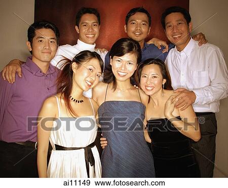 Group of friends posing for a picture, looking at camera View Large Photo Image Stock Photo - Group of friends posing for a picture, looking at camera. Fotosearch