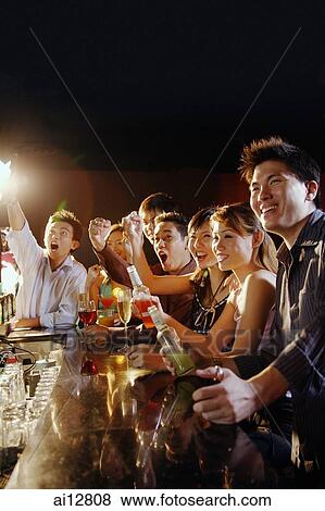 Group of friends sitting at bar, looking away View Large Photo Image Stock Photo - Group of friends sitting at bar, looking away. Fotosearch